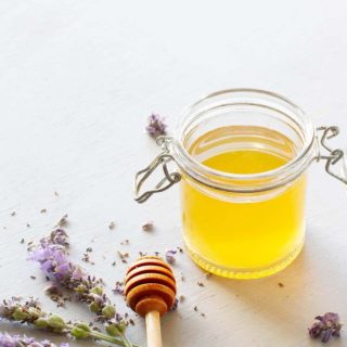 A glass jar of honey lavender syrup