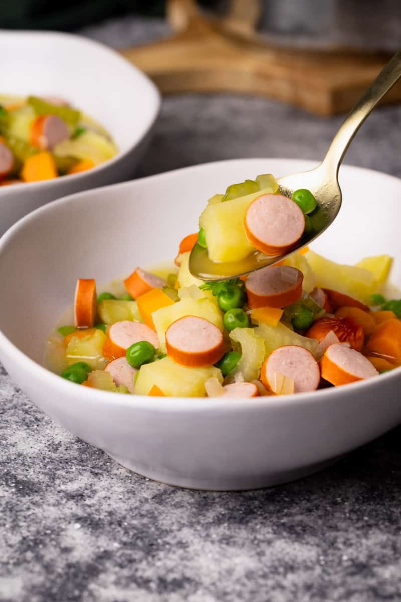 German stew with Franks in white soup bowls.