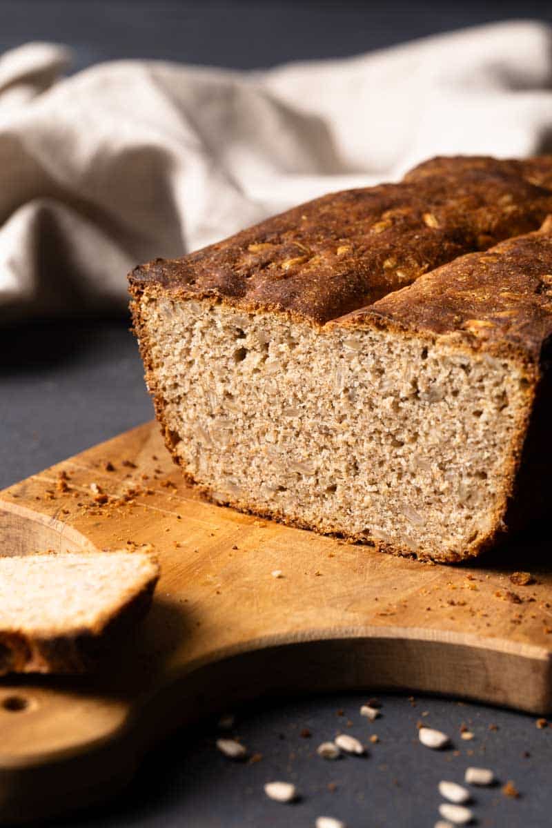 A seeded rye sandwich bread on a wooden board.