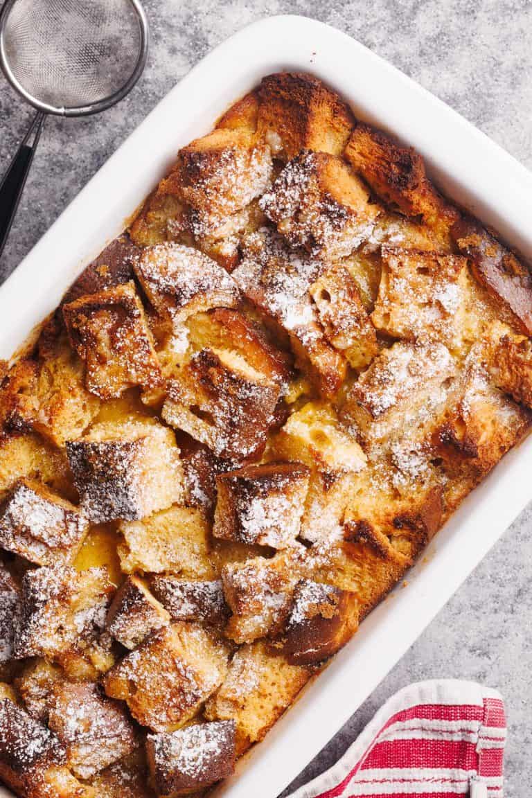 French toast casserole top down in a white baking dish.