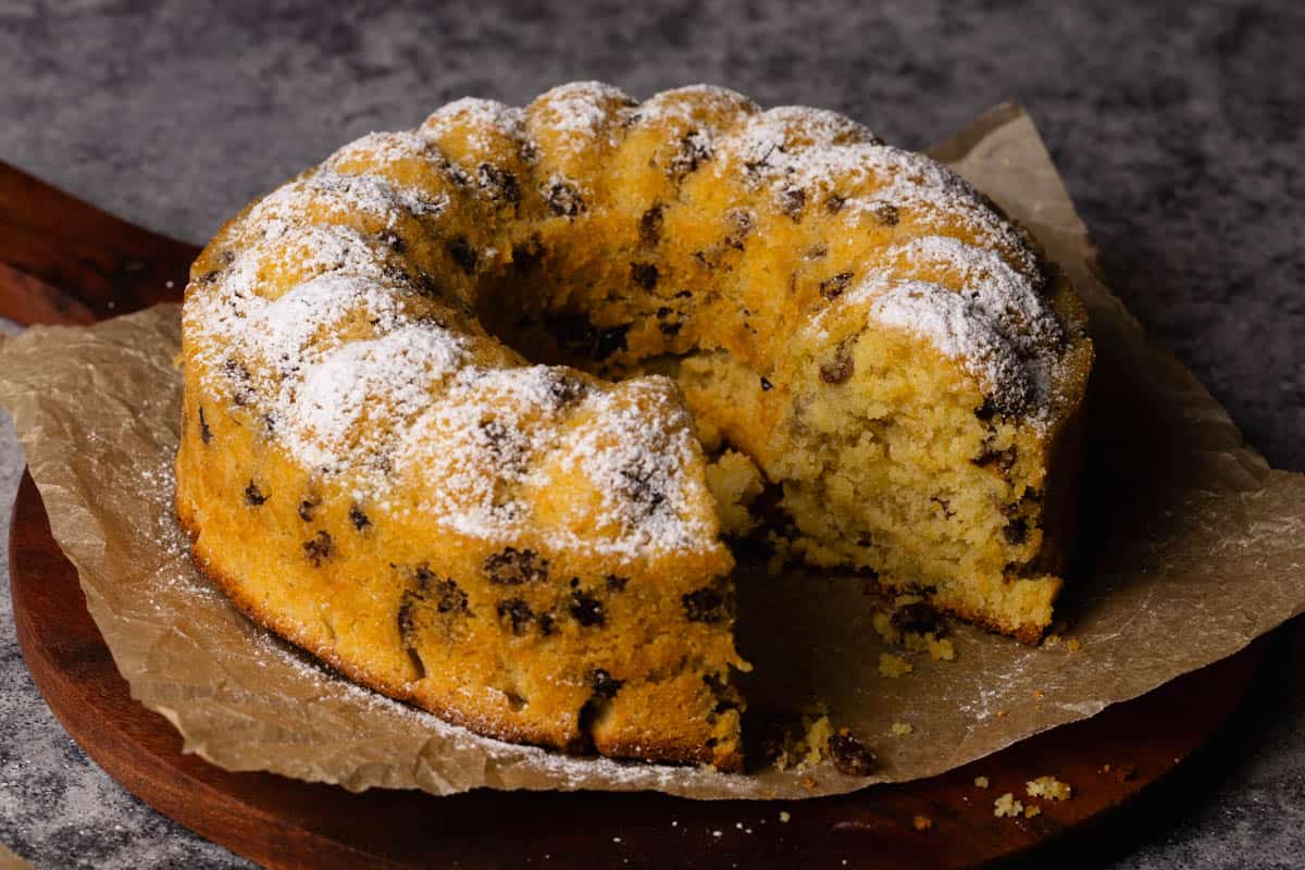 A raisin cake on a wooden board.