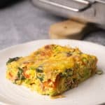 A slice of veggie egg bake in a plate.
