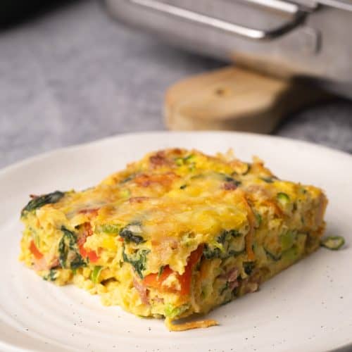 A slice of veggie egg bake in a plate.