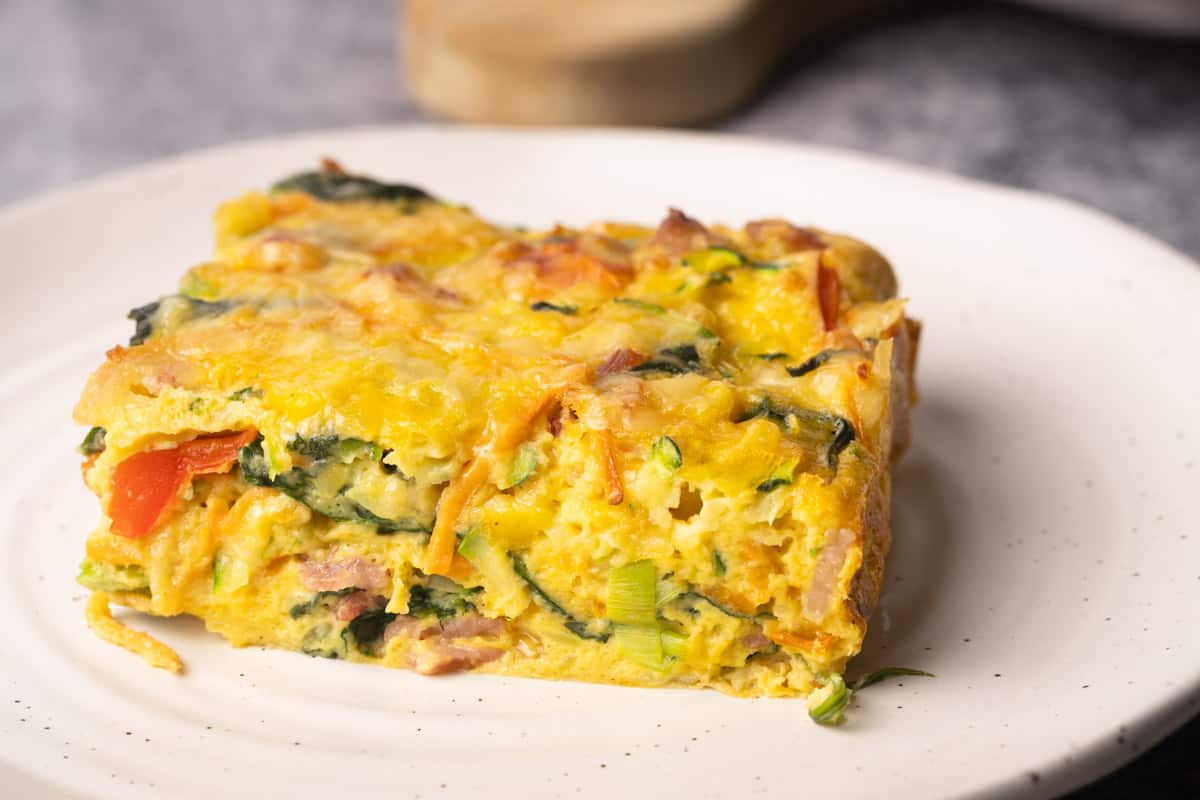 A slice of veggie egg bake in a plate.