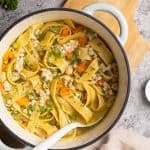 Chicken soup with noodles in a large Dutch oven.