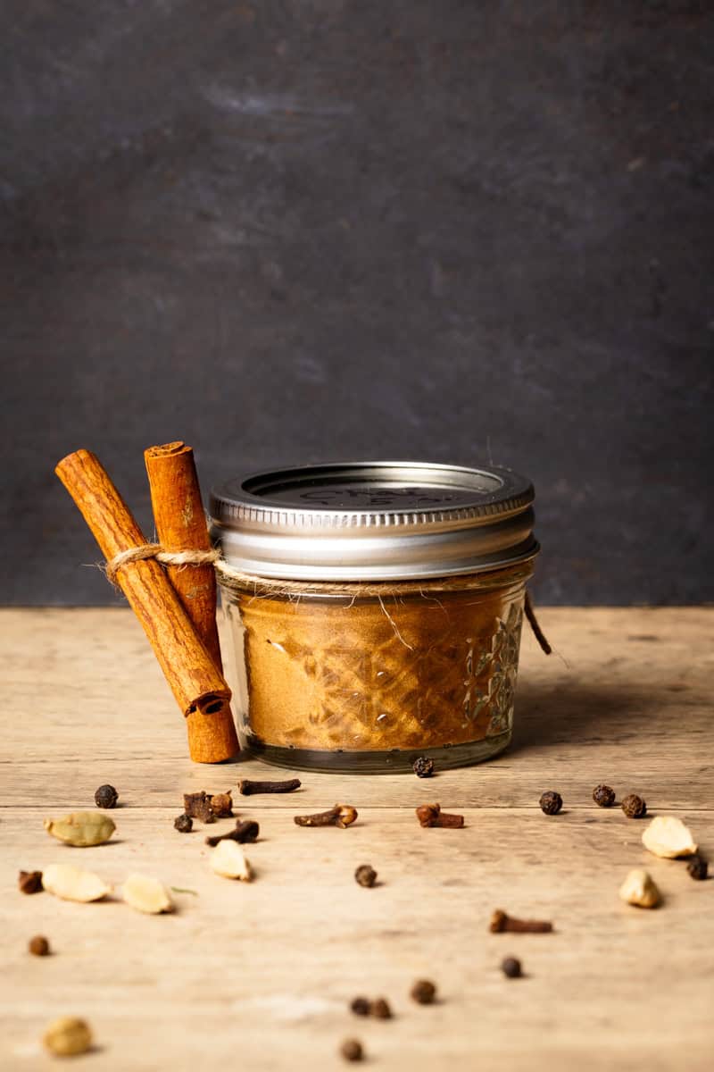A jar of homemade Masala chai spice mix as a food gift with cinnamon quills.