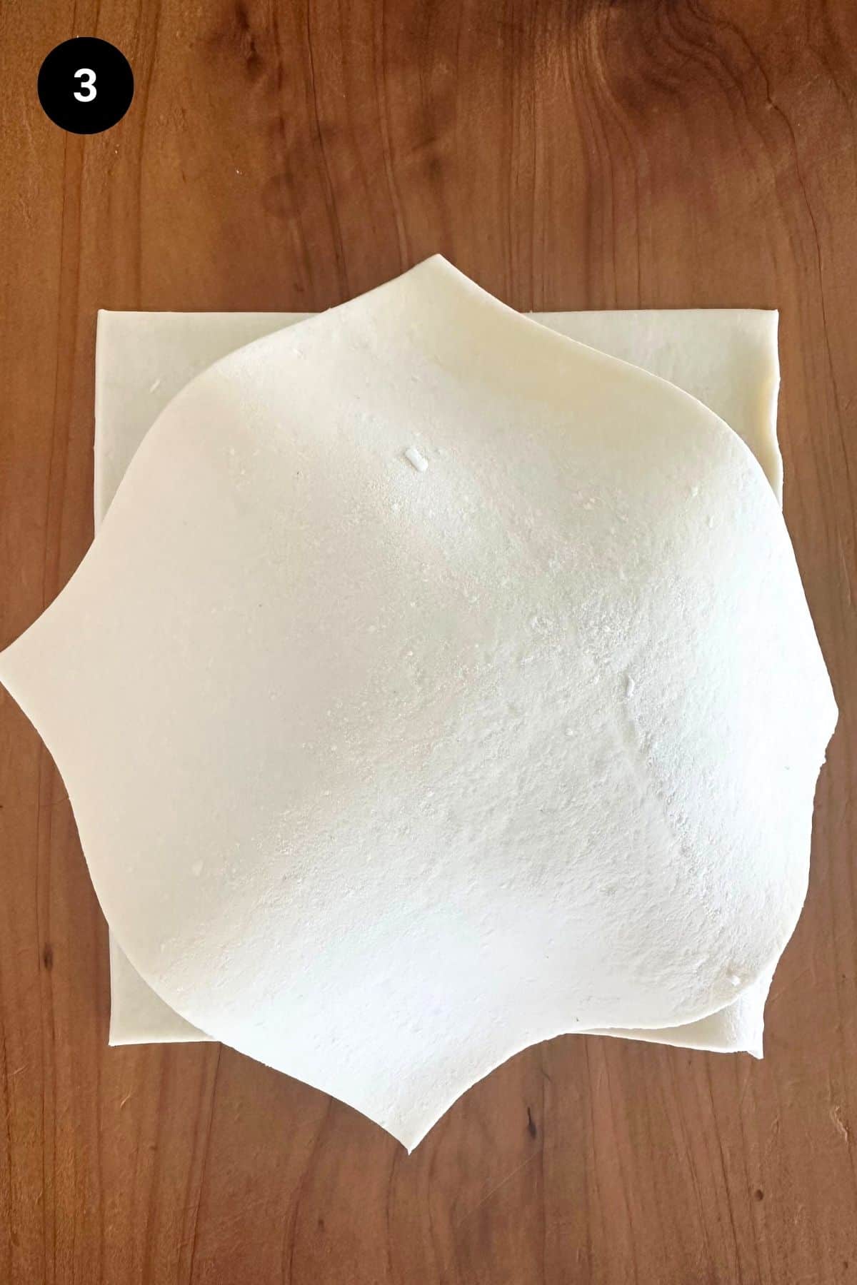 Pastry being folded on a single serve lamb wellington.