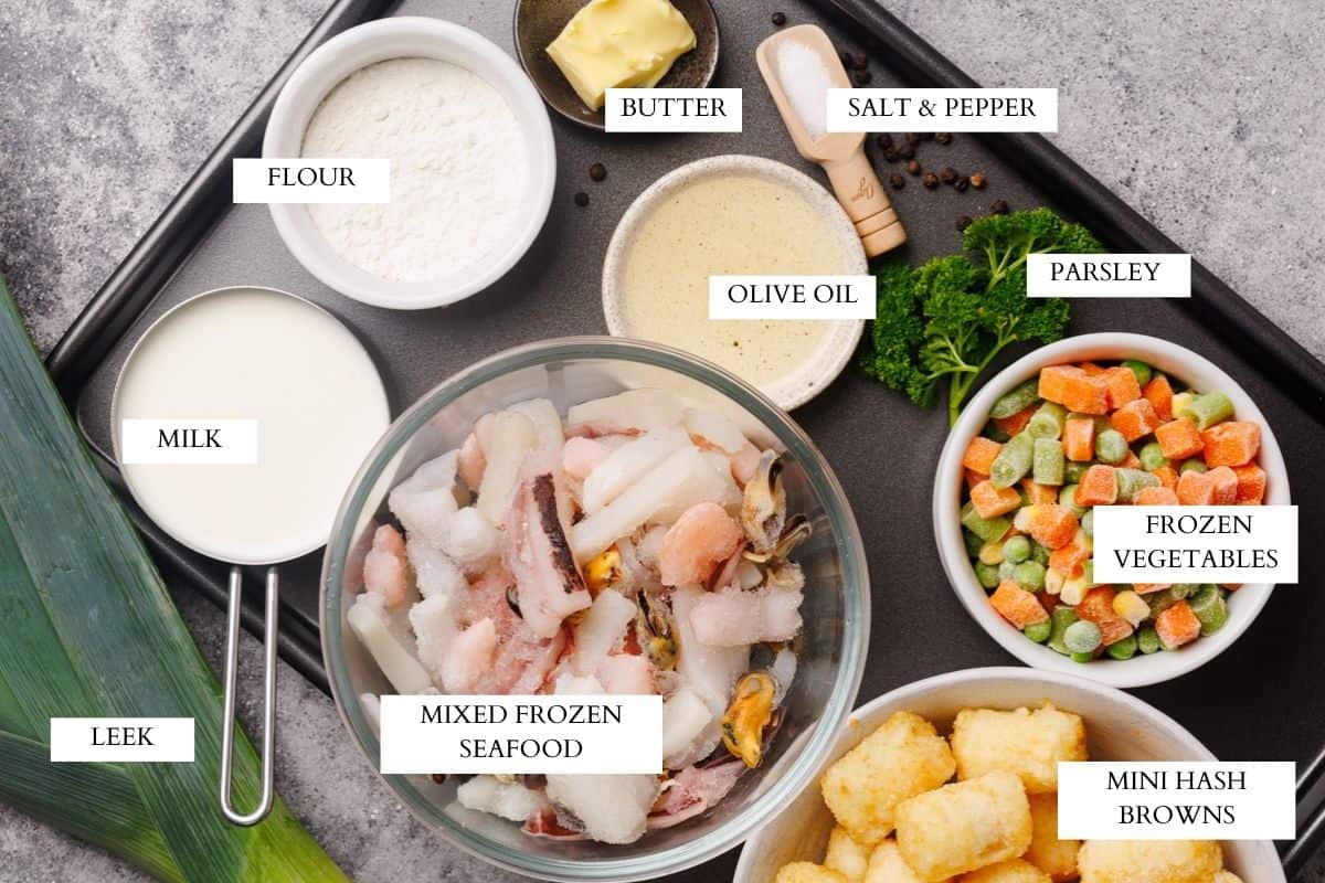 Ingredients laid out on a metal tray to make seafood pie.