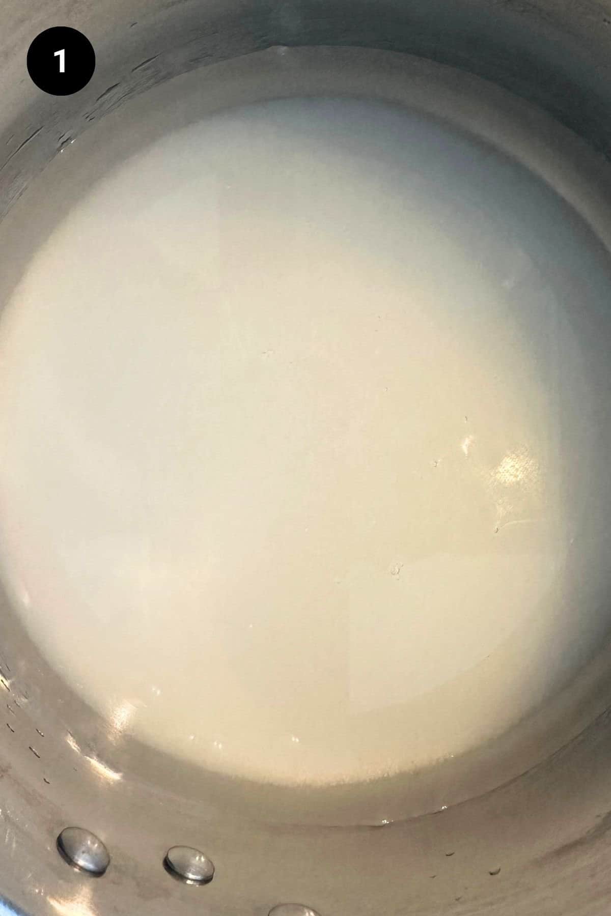 Simple syrup being made in a saucepan.