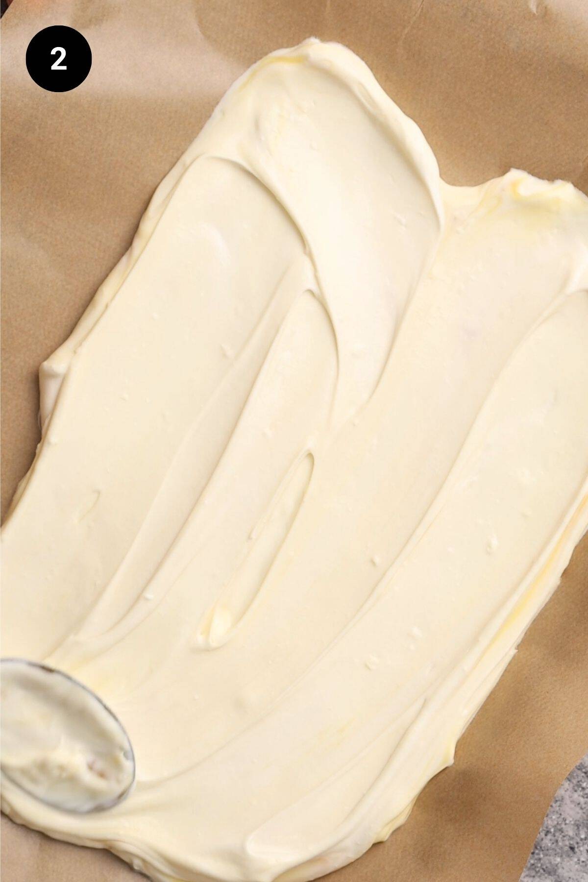 Yogurt spread out on a lined baking tray.