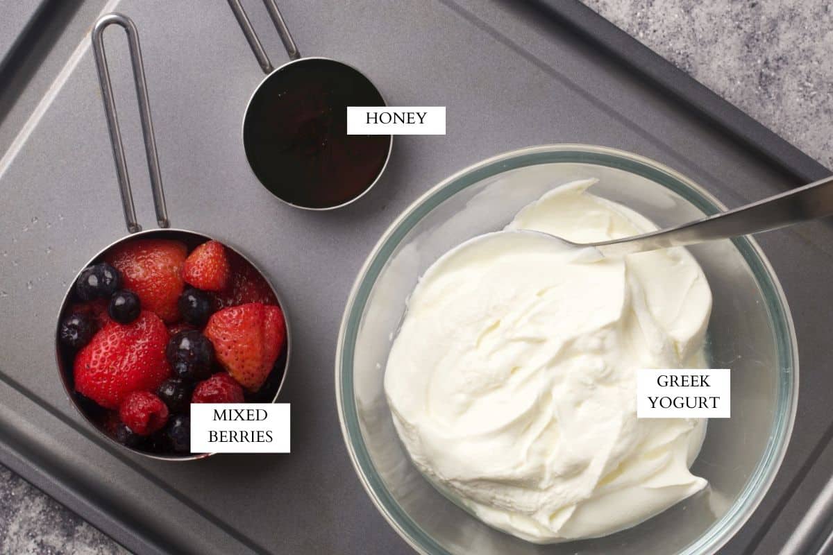 Ingredients needed to make yogurt bark with berries.
