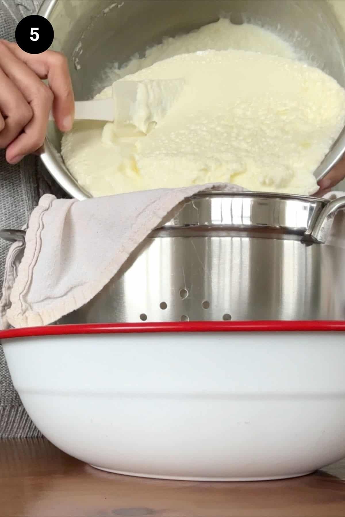 Yogurt being poured into a muslin lined colander.
