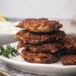 A stack of beef fritters on a white plate.