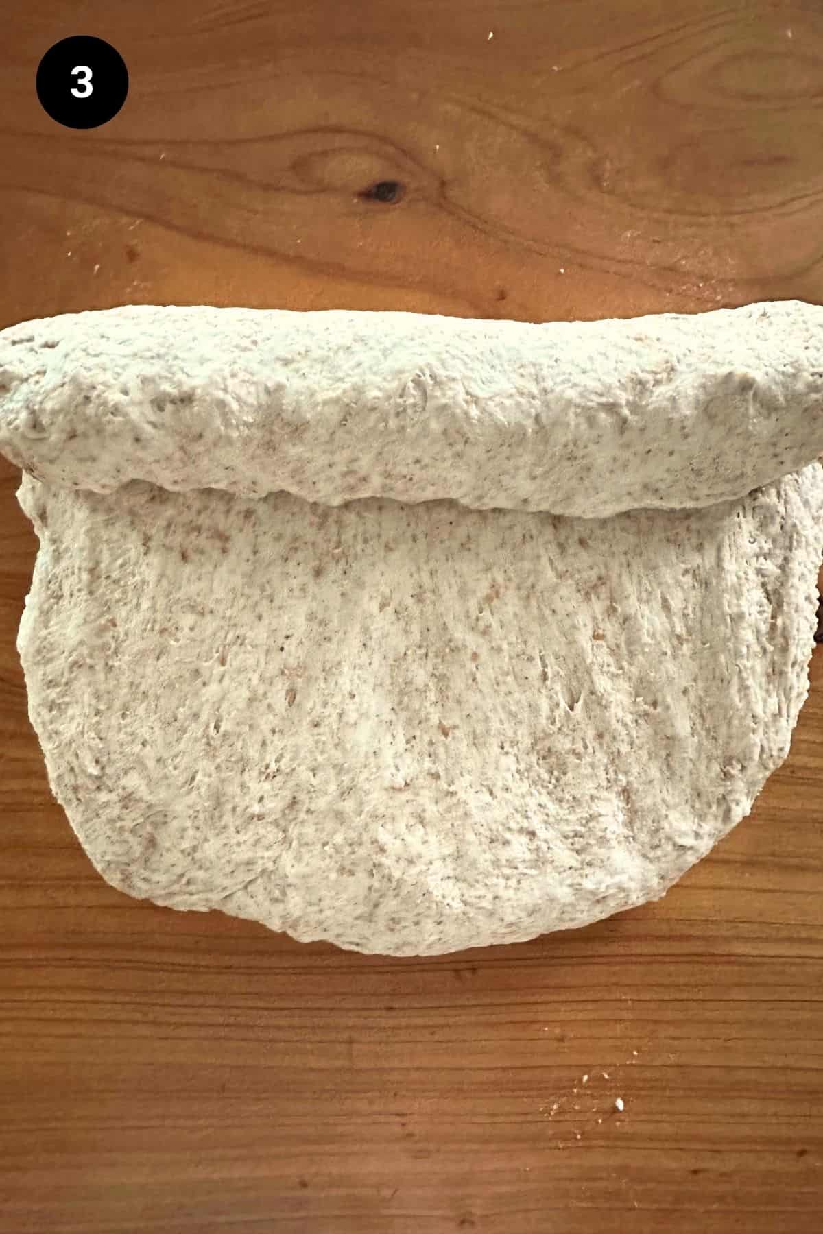 A cold fermented loaf being shaped.
