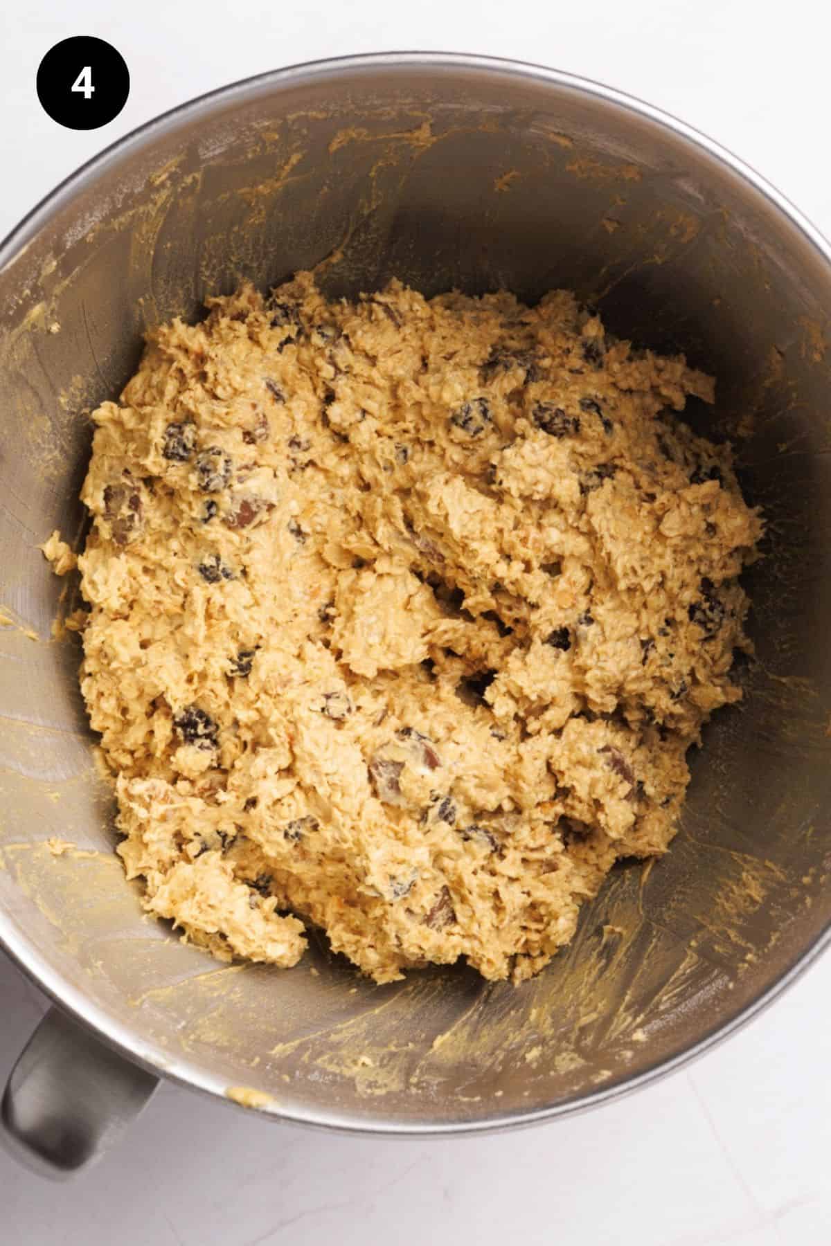 Dried fruit, chocolate, and walnuts are now well combined in the metal bowl.