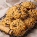 A wire basket filled with energy cookies on a linen cloth.