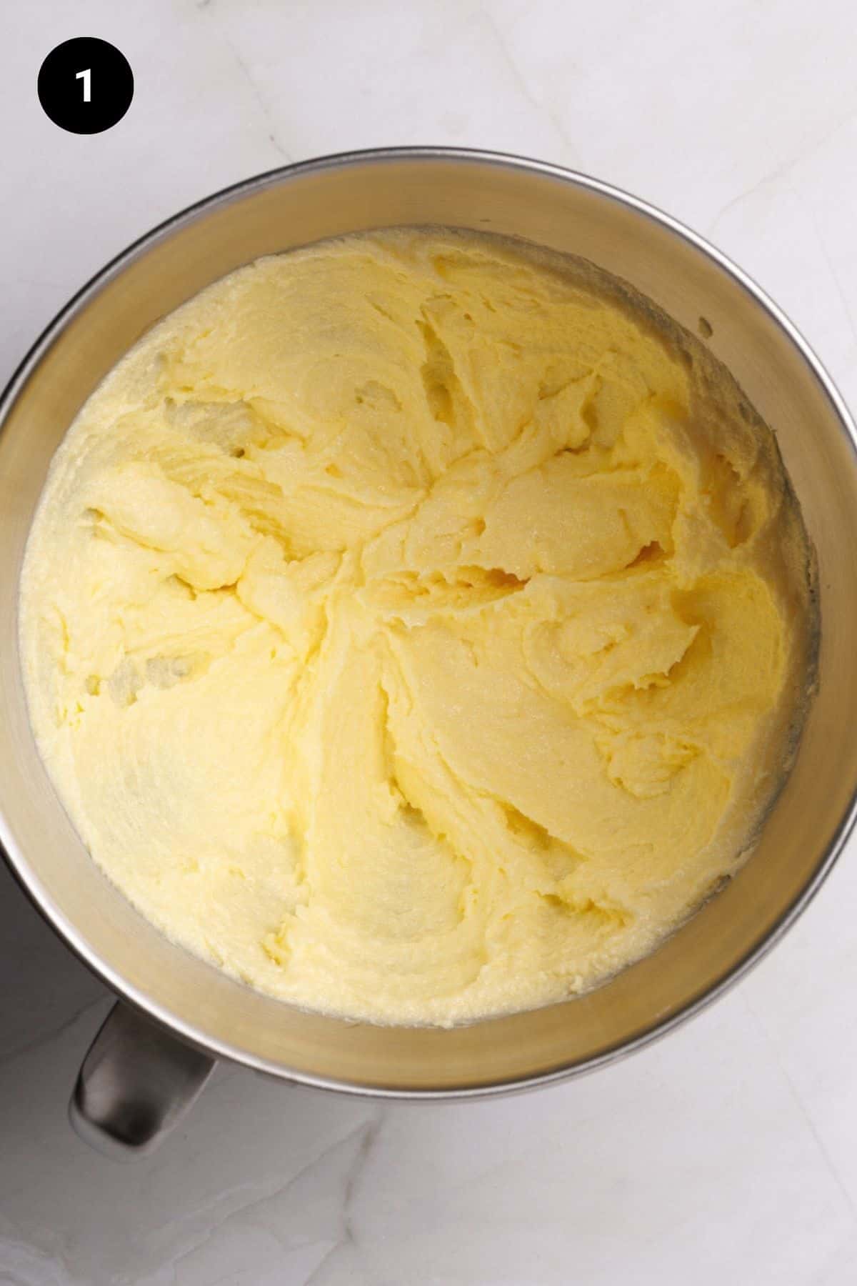 Creamed butter and sugar in a metal bowl.