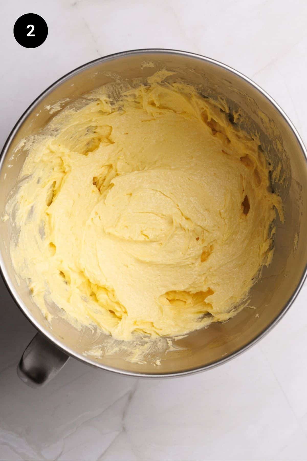 Fluffy dough in a metal bowl.