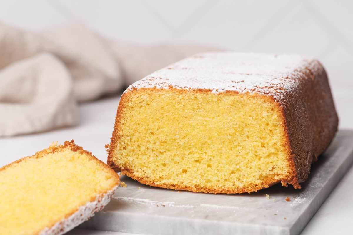 Vanilla pound cake on a marble tray, white background.