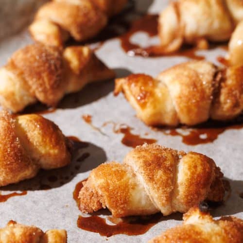 Mini apple croissants on a baking tray.