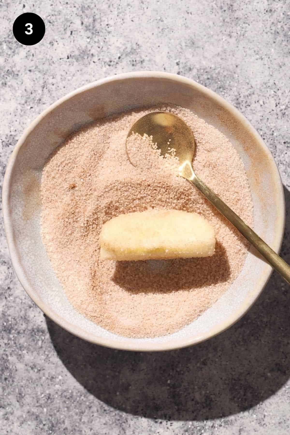 Apple wedge in cinnamon sugar.