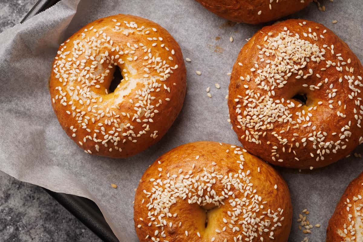 Pretzel bagels on a baking tray.