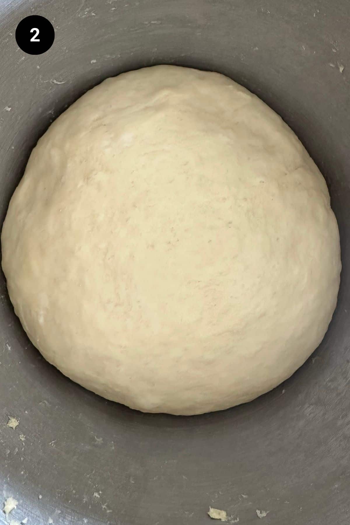 Pretzel dough in a metal bowl.