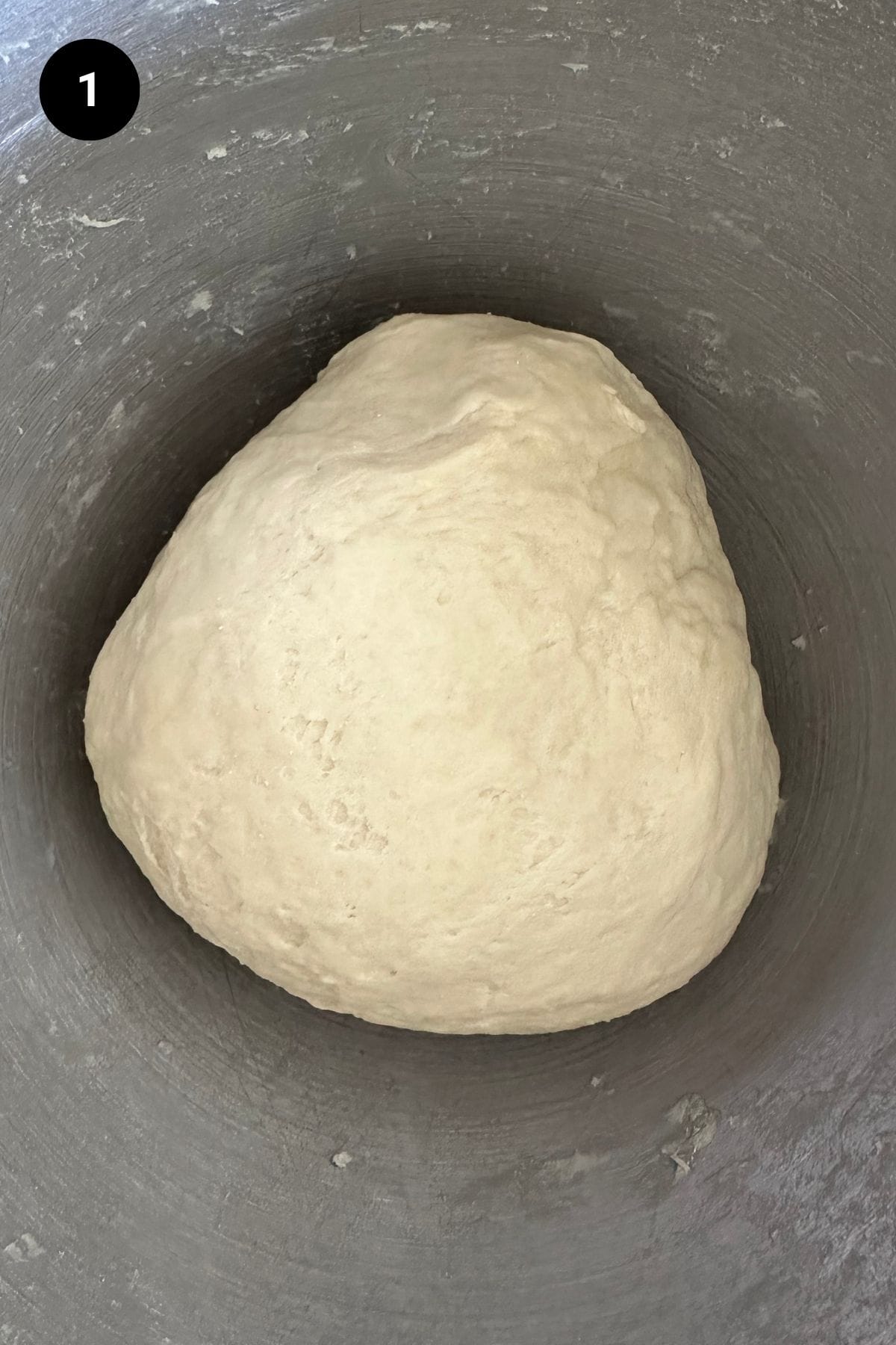 Pretzel dough in a metal bowl.