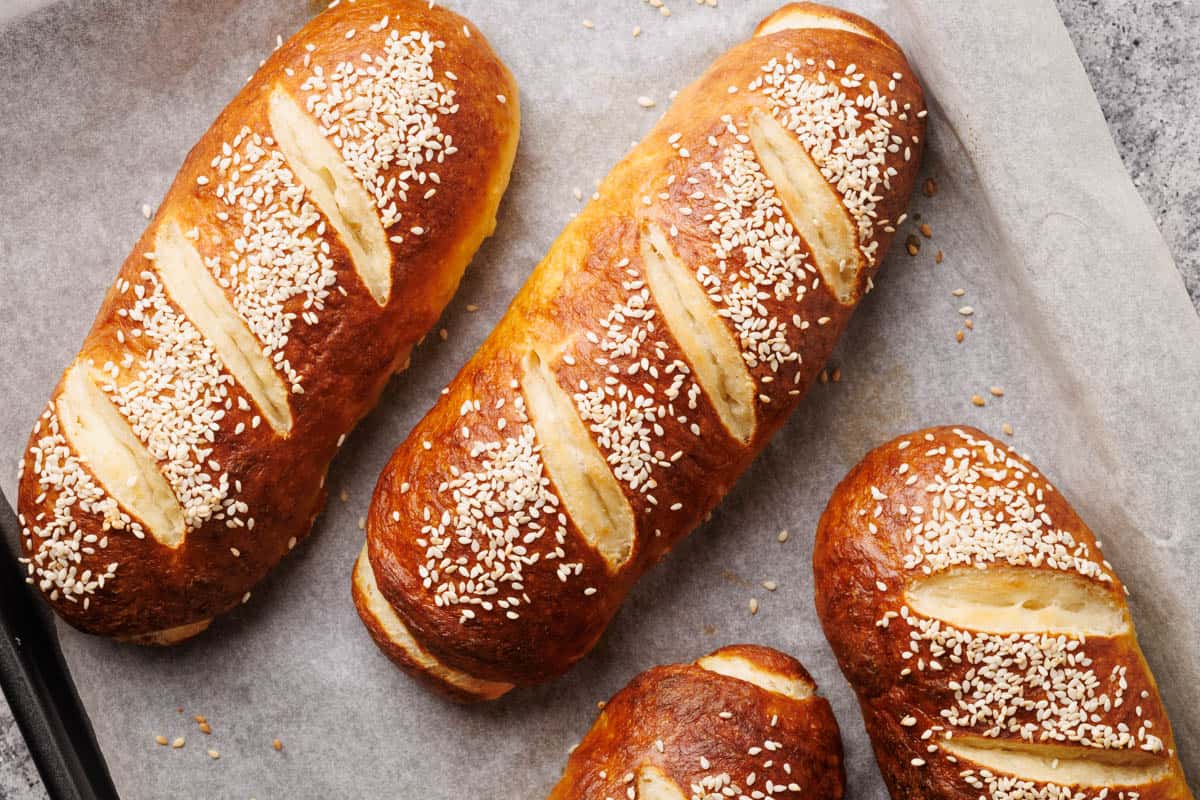 Pretzel buns on a baking tray.