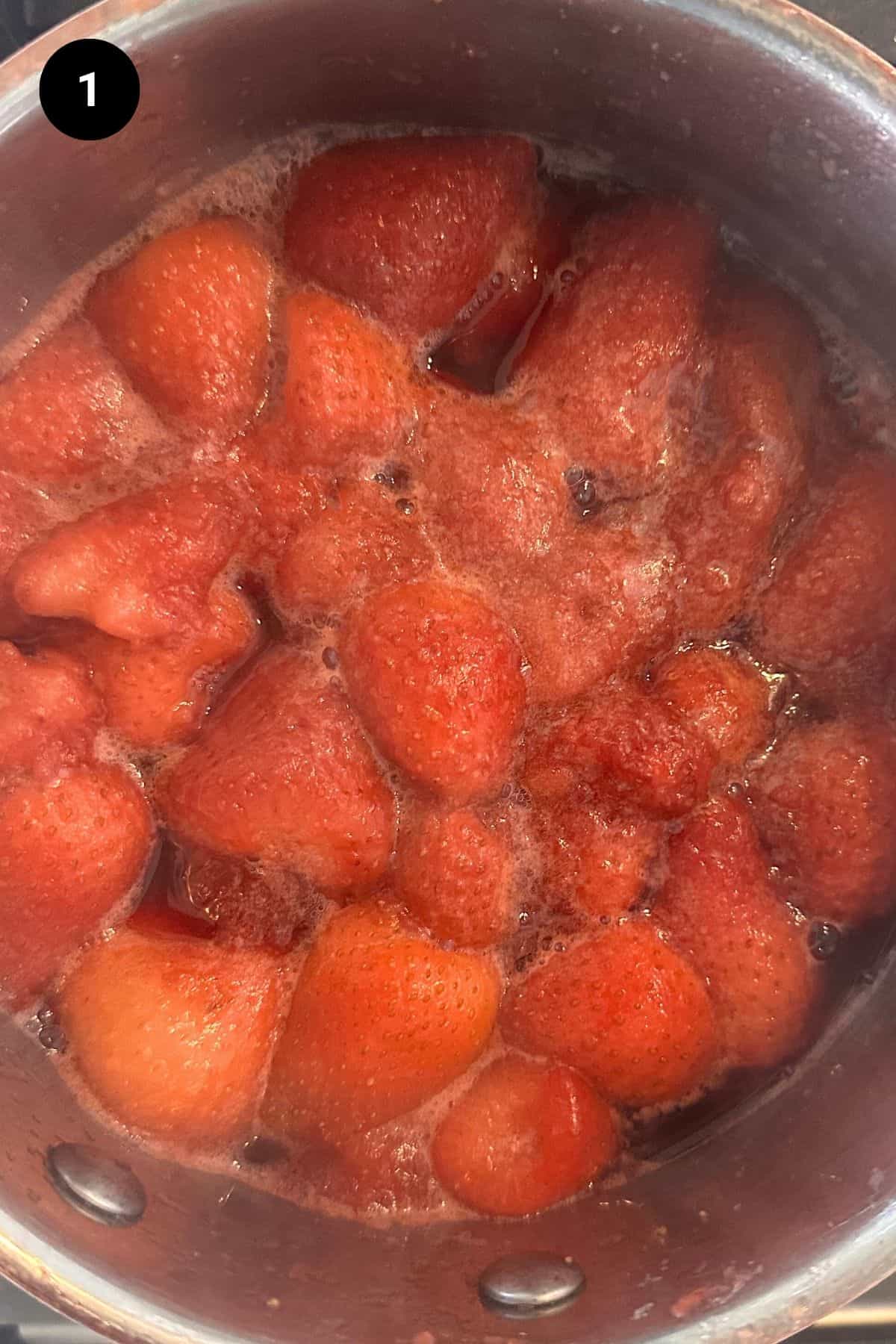 Strawberries being stewed in a saucepan.