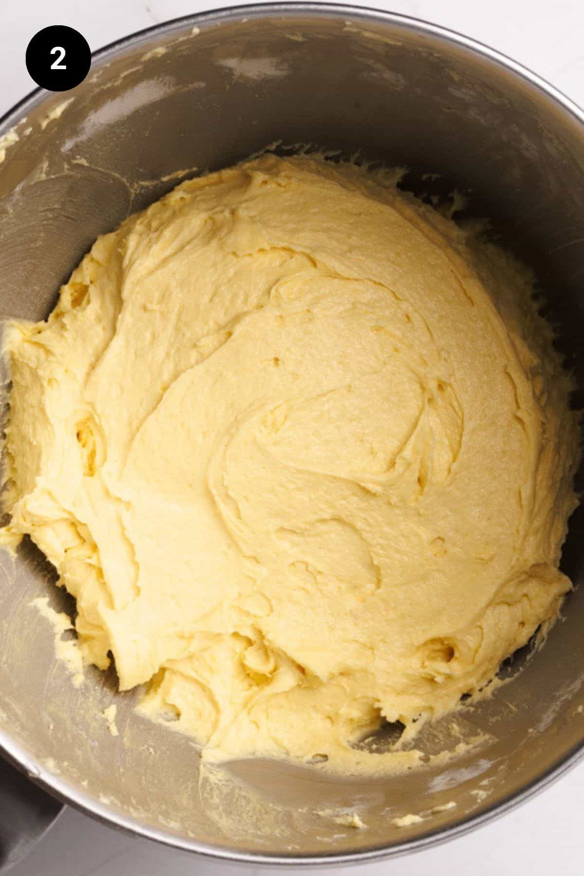 Cake batter in a metal bowl.