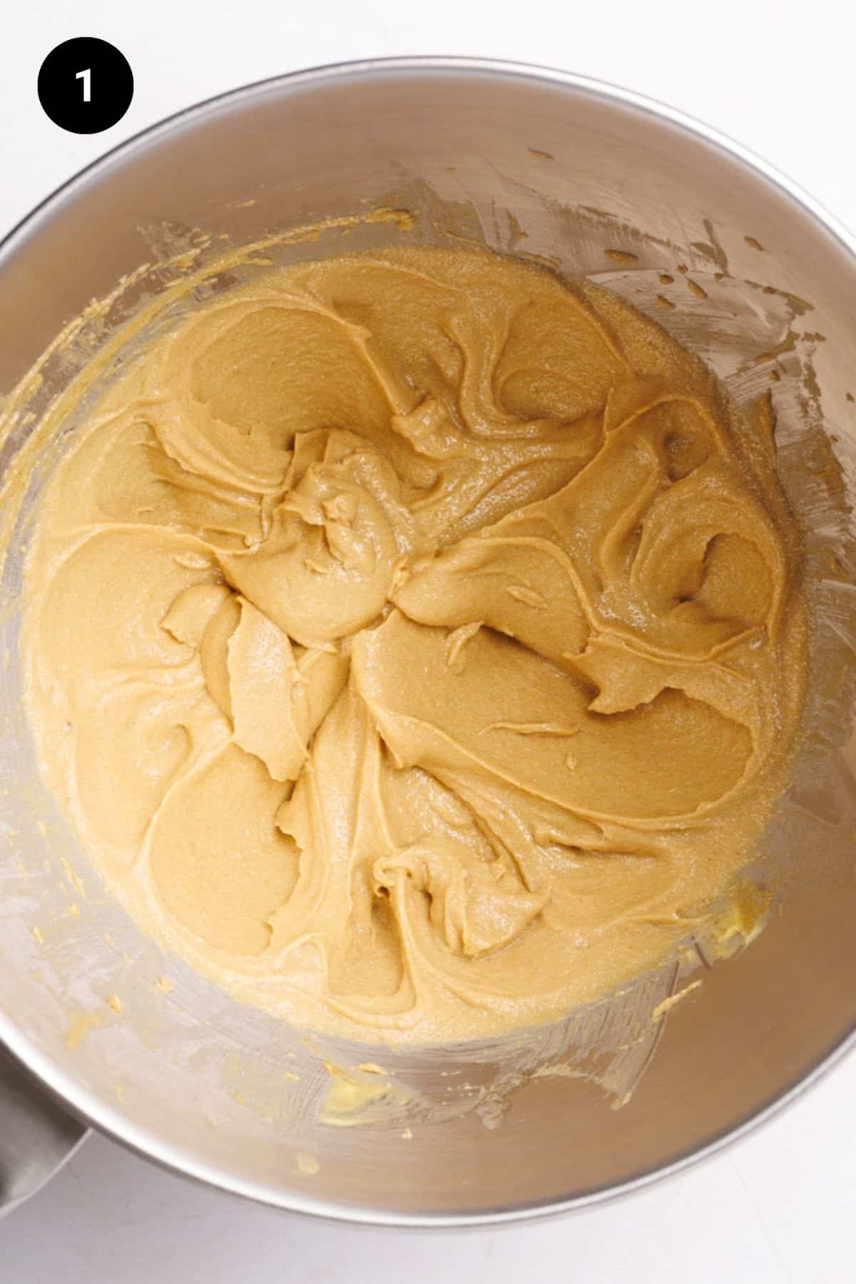 Creamed butter and sugar in a metal bowl.