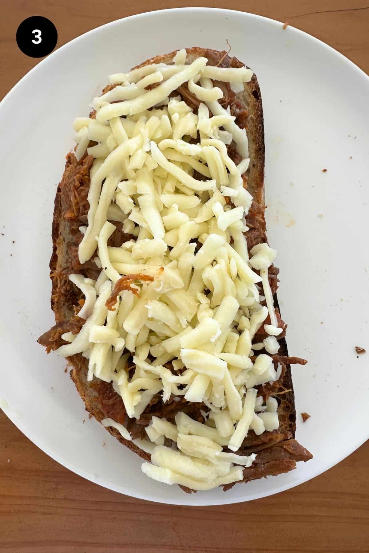 Bread slice on a white plate with fillings.