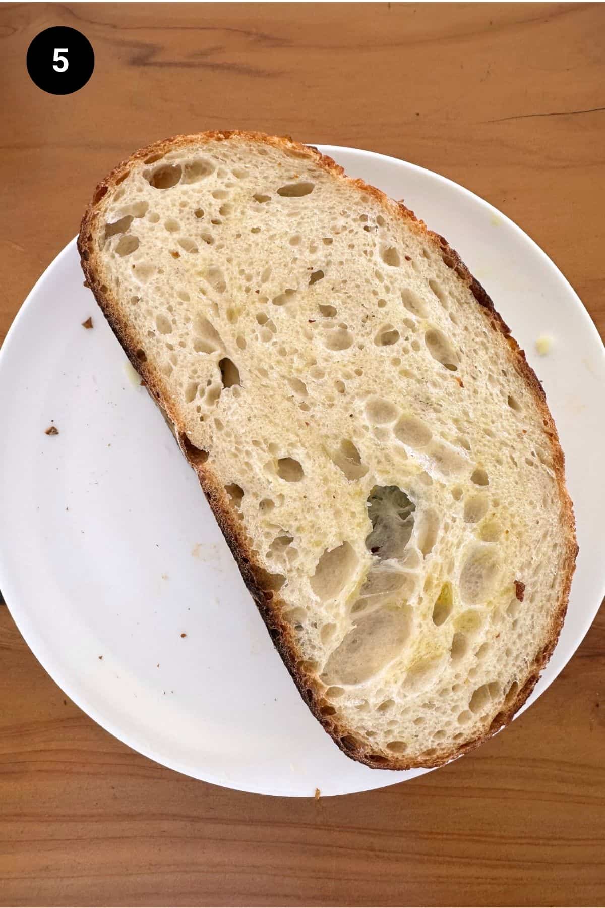 Sandwich on a white plate ready to be grilled.