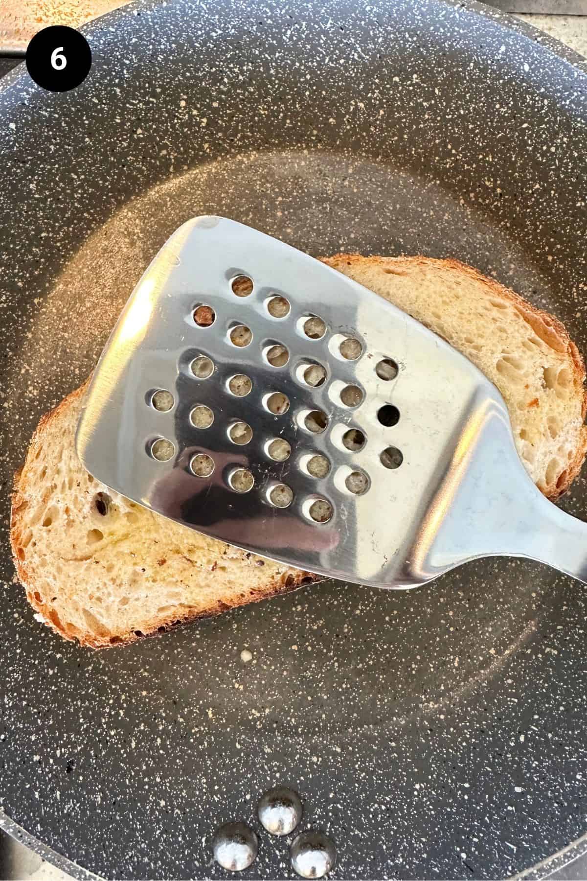Sandwich being grilled in a pan.