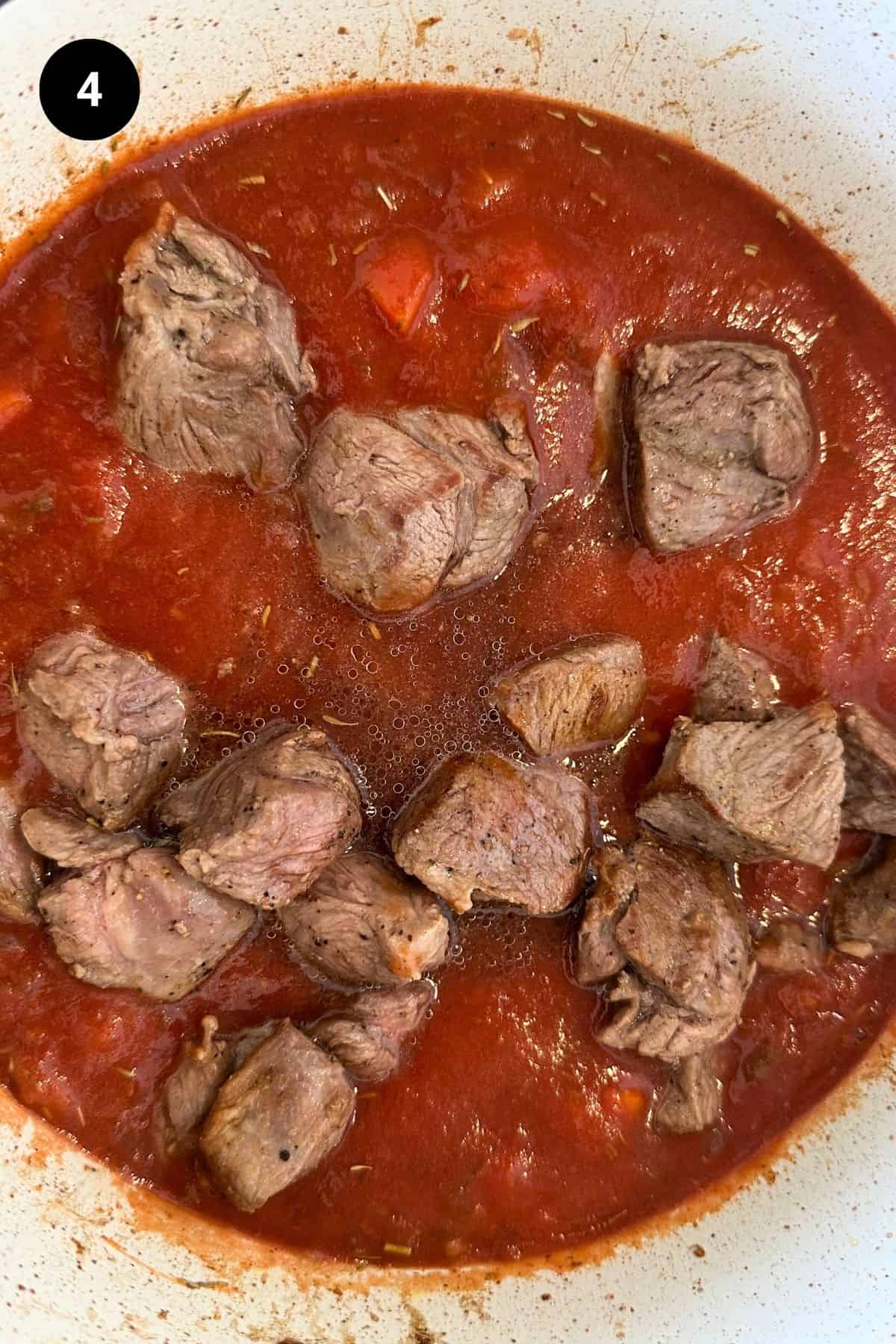 Browned meat added to the tomato sauce.