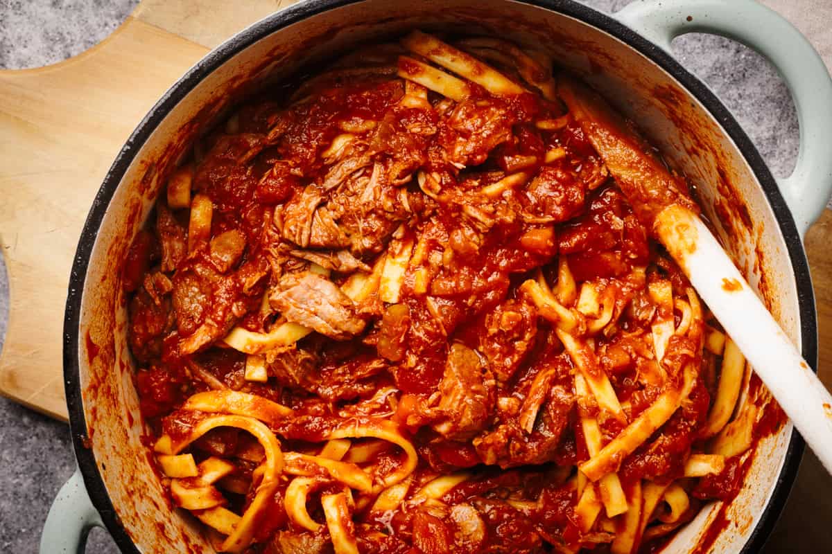 Lamb ragu with tagliatelle in a Dutch oven.