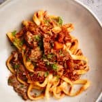 Lamb ragu with tagliatelle in a pasta bowl.