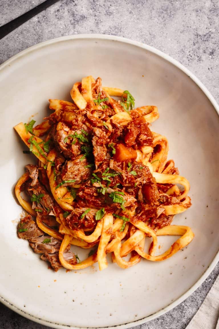 Lamb ragu with tagliatelle in a pasta bowl.