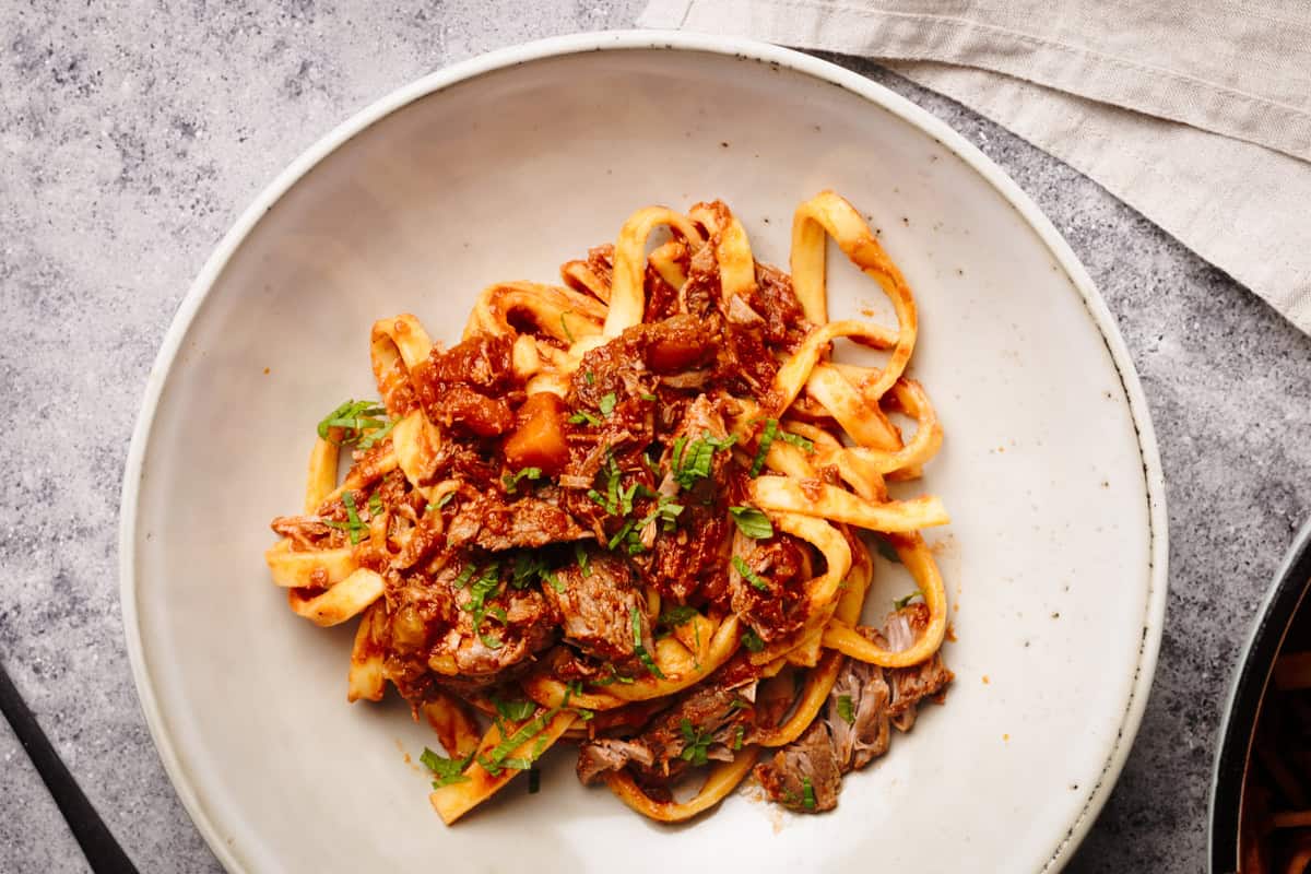 Lamb ragu with tagliatelle in a pasta bowl.