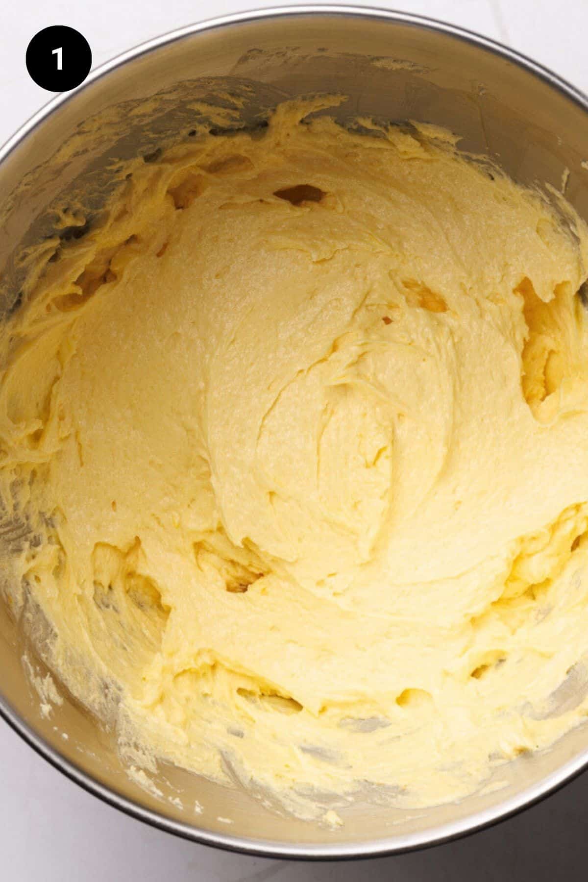 Creamed butter and sugar in a metal bowl.