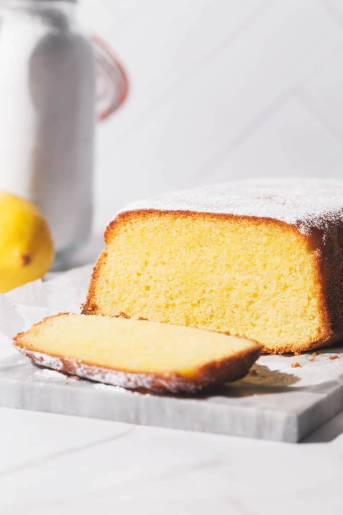 Lemon pound cake sliced on a marble slate.