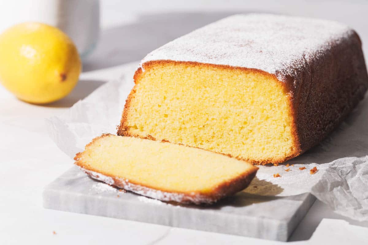 Lemon pound cake sliced on a marble slate.