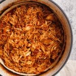 Pulled chicken in a Dutch oven.
