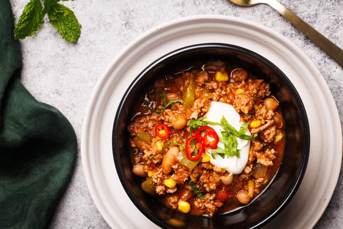 Chili served in black bowls.