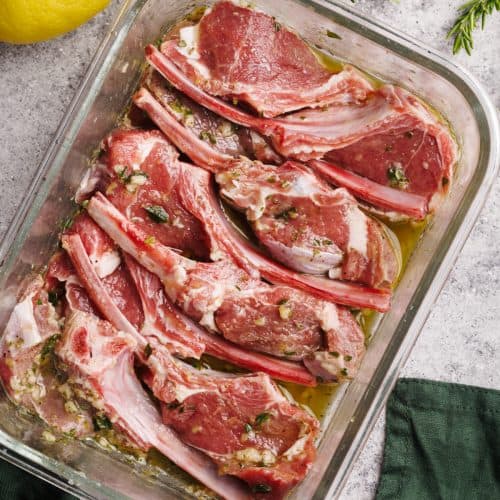 Lamb chops being marinated in a galls bowl.