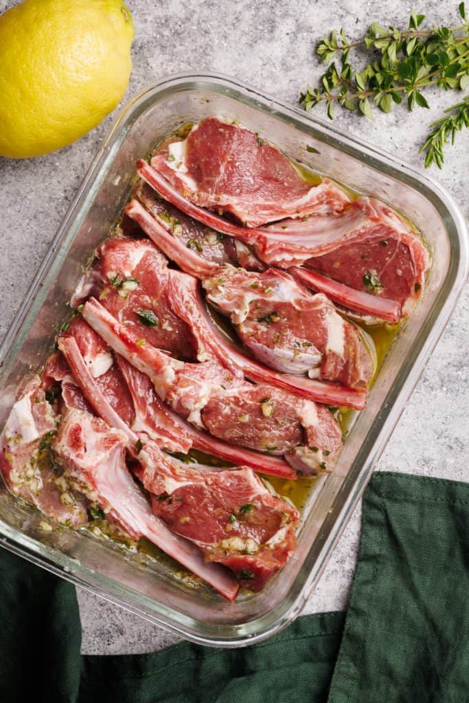 Lamb chops being marinated in a galls bowl.
