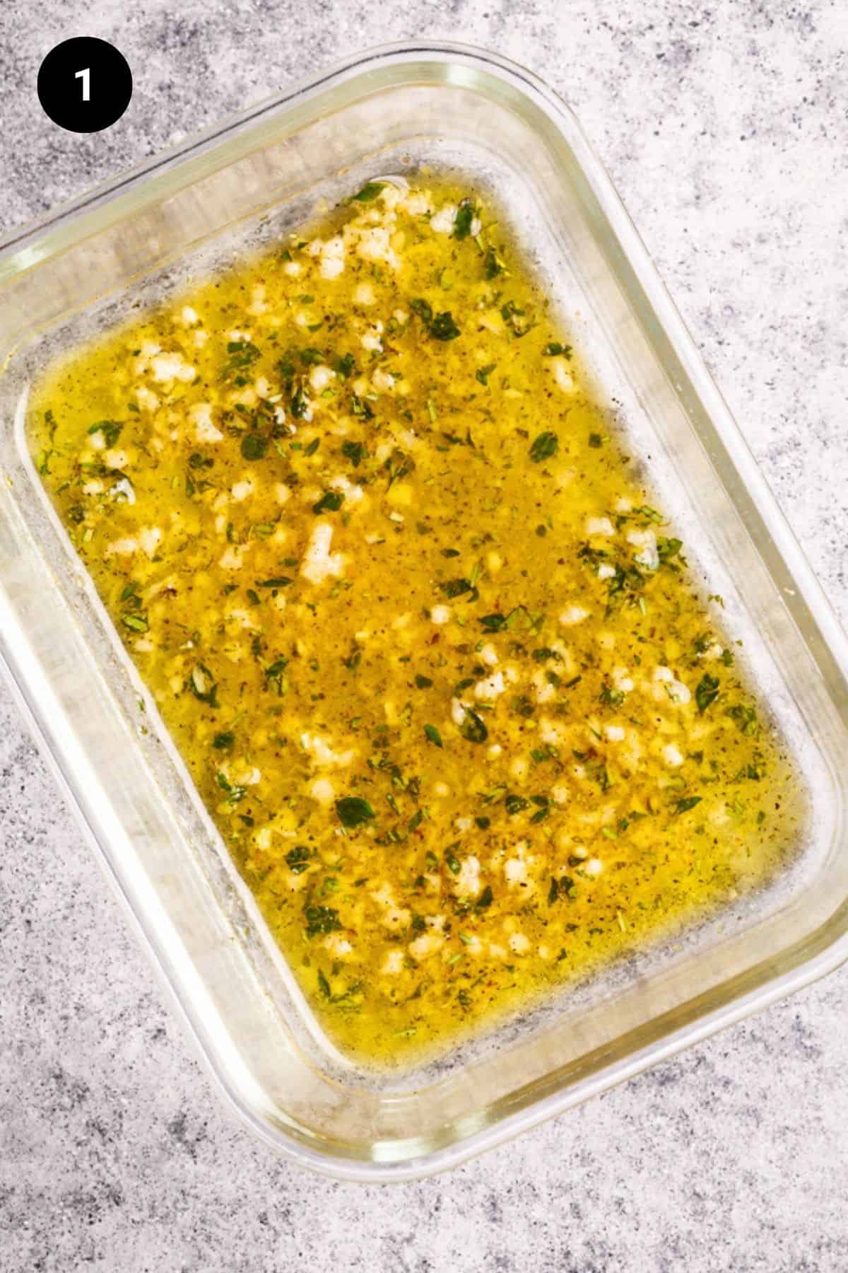 Lamb marinade in a glass container.