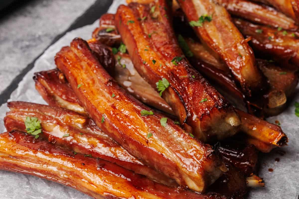 Lamb ribs in a black slate.