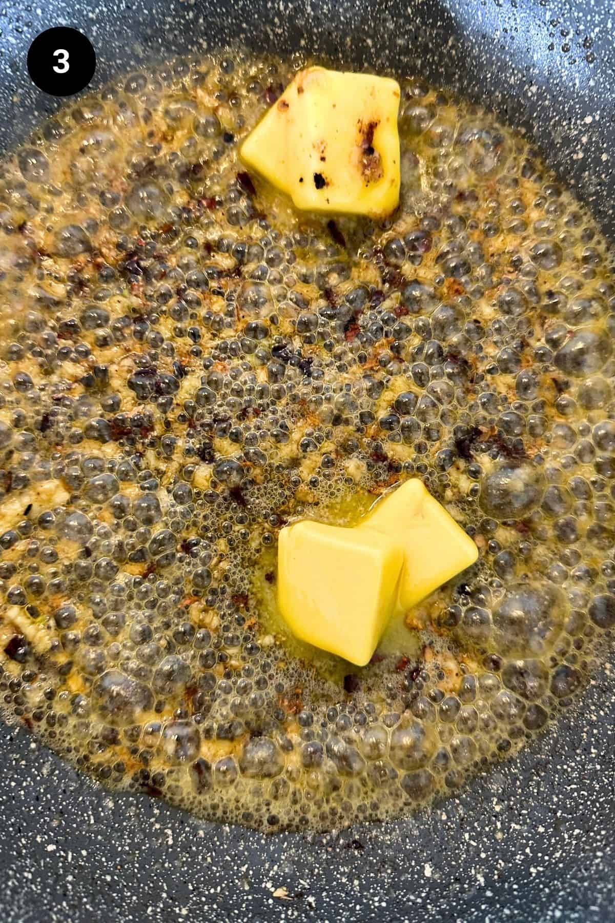 Butter melting in a pan in olive oil